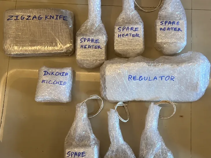 Spare heaters, a zigzag knife, a regulator and chips bubble-wrapped and labelled for dispatch